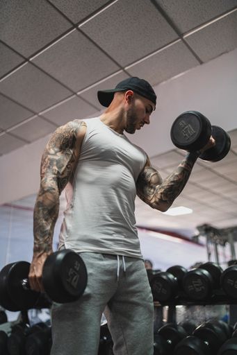 The handsome man doing a workout in the gym