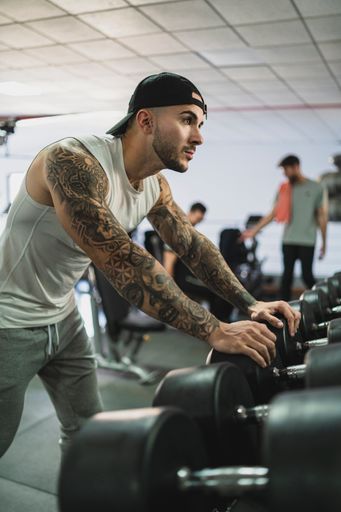 The handsome man doing a workout in the gym