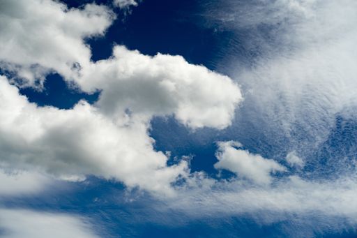 A low angle shot of a blue cloudy sky at daytime - perfect for wallpapers and backgrounds