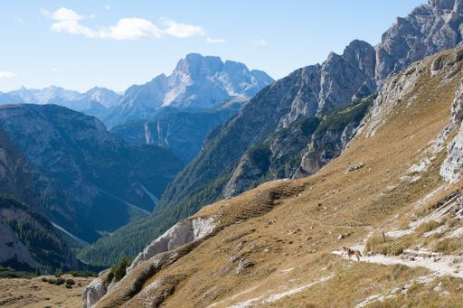 A landscape view of beautiful mountains under a blue cloudy sky on a sunny day
