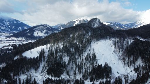 A beautiful shot of mountains partly covered in snow.