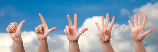 A panoramic shot of hands counting from one to five