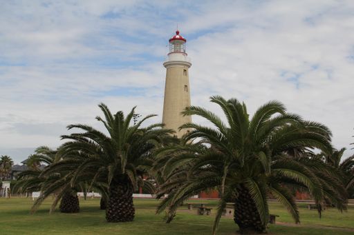 The Faro de Punta del Este surrounded by greenery under a cloudy sky in Uruguay