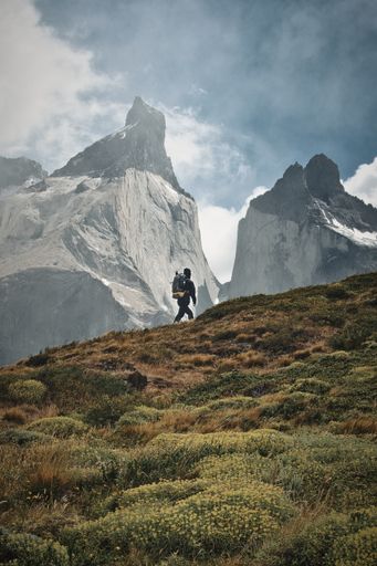 A vertical shot of the man hiking towards Mirador el Condor. Torres del Paine National Park, Peru.