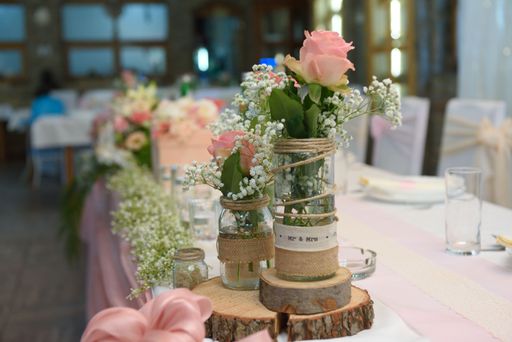 A selective focus shot of an elegant table arrangement with beautiful flowers in a wedding reception