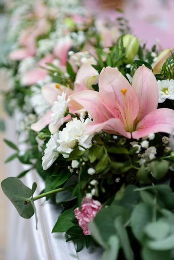 A selective focus shot of beautiful flower arrangements on the table in wedding reception