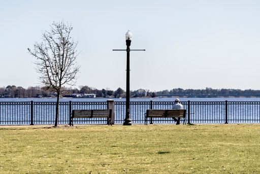 The beautiful shot of a person sitting on a park bench, Union Point Park in New Bern, North Carolina