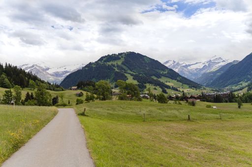 A beautiful pathway in a mountain landscape on a cloudy sky background