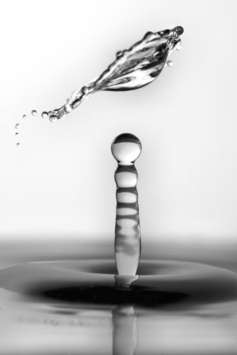 A closeup of a water splash on a grey background
