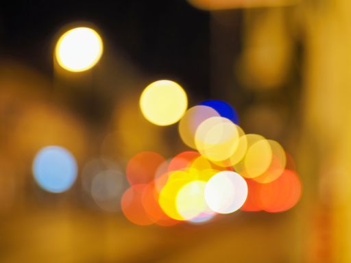 A bokeh filter background with brown lights against an out of focus street