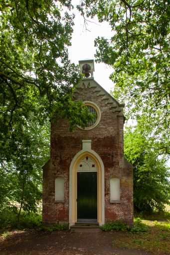 A vertical shot of an old chapel in the forest at the Sandwijck Estate near Utrecht in the Netherlands