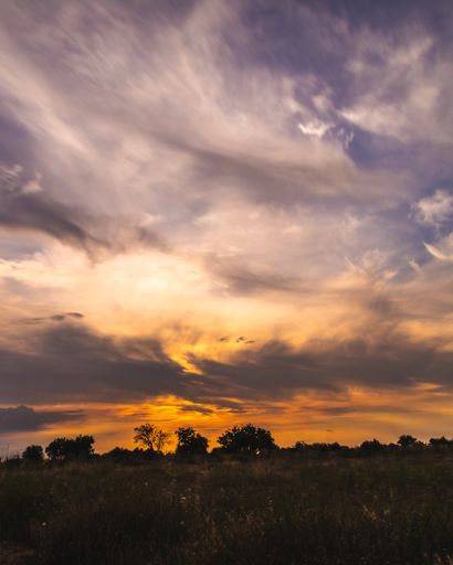 A beautiful landscape gleaming under the cloudy sky and the breathtaking golden sunset