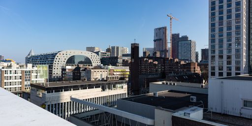 A distant view of the Market Hall surrounded by other buildings in Rotterdam, Netherlands