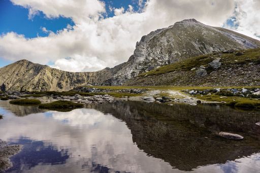 An amazing shot of a reflective lake in a mountain landscape