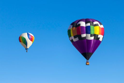 An aerial view of hot air balloons in the bright sky in Albuquerque, USA