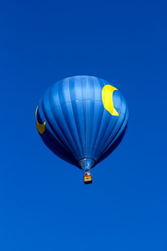 A vertical shot of a hot air balloon in the bright sky in Albuquerque, USA