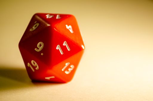 selective focus 20-sided red dice for role-playing game isolated on warm background rpg