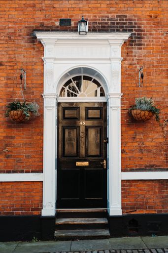 English style beautiful entrance to the building, brick wall, flowers in a pot, Nottingham , England, UK