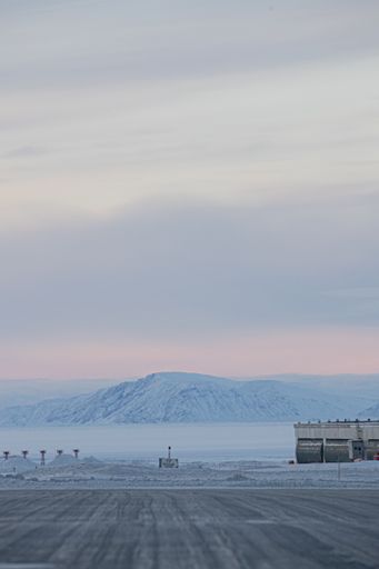 The beautiful mountains covered in snow  in winter and gleaming under the cloudy colorful sky