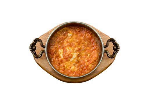 A top view of Menemen Turkish dish with egg and tomatoes in pan isolated on a white background