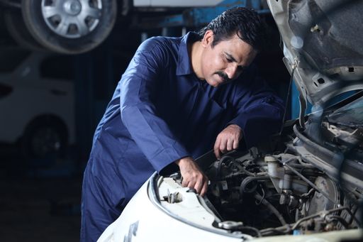 A mechanic working on a car in a garage