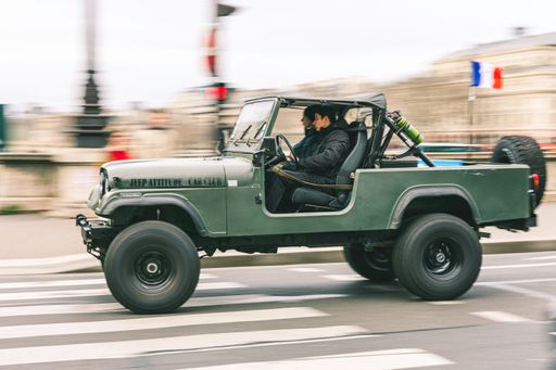 An old classic green off road car in the city, Jeep CJ8