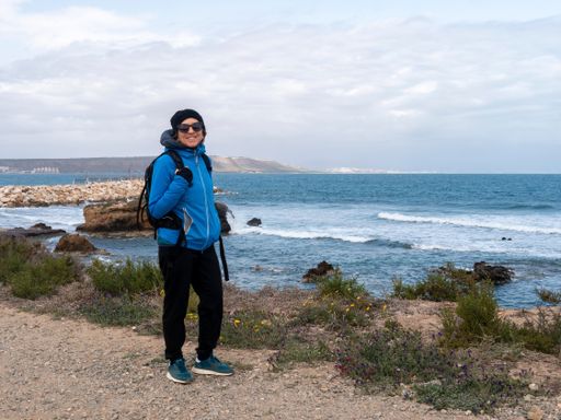 A closeup shot of a Caucasian man standing near the beach