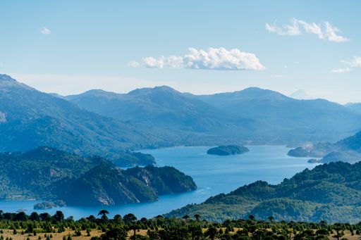 An aerial view of a beautiful lake near the mountains
