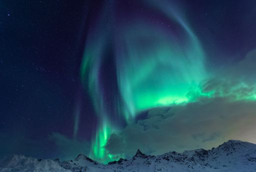 A beautiful shot of the Northern lights over the sea near Tromso, Norway