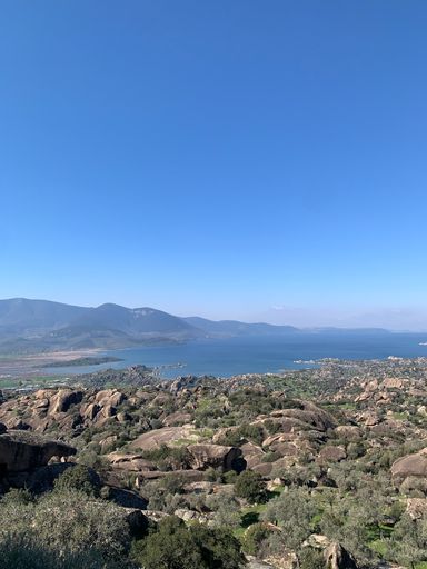 A natural view of the vast landscape, Bafa Lake, and the ancient city of Turkey under a clear sky