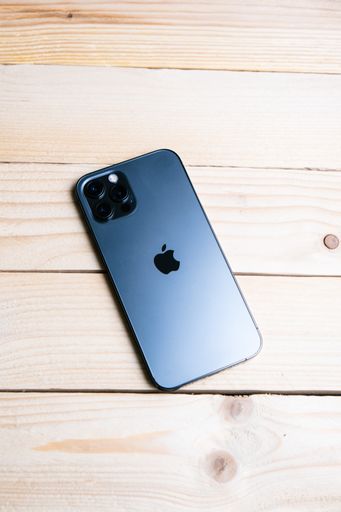 A top view of new Iphone 13 on a wooden table