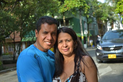 A selective focus shot of a Caucasian couple smiling at the camera