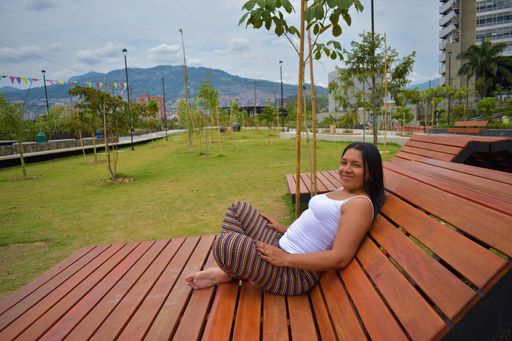 A closeup shot of a Latin brunette having a rest on the bench in the park