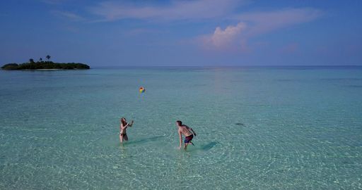 A couple relaxing on the beach in the Maldives