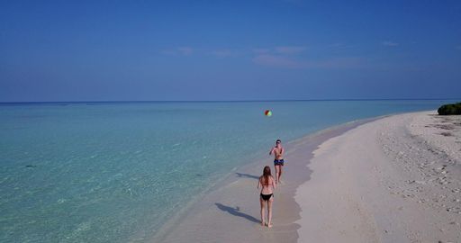 A couple relaxing on the beach in the Maldives