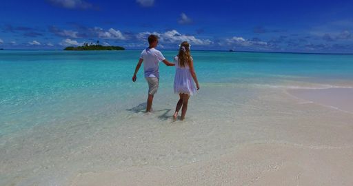 A young couple enjoying their vacation at the beautiful island of Rasdhoo in the Maldives