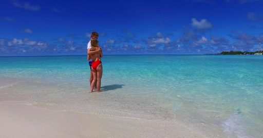 A beautiful shot of a Caucasian couple admiring on a beach in Rasdhoo Island, The Maldives