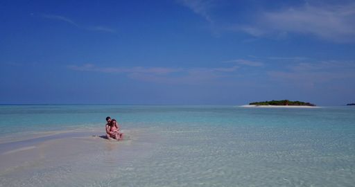 A beautiful shot of a Caucasian couple on a beach in Rasdhoo Island, The Maldives