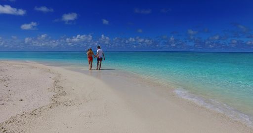 A beautiful shot of a Caucasian couple admiring on a beach in Rasdhoo Island, The Maldives