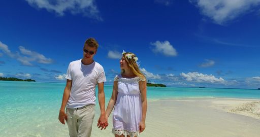 A beautiful shot of a Caucasian couple admiring on a beach in Rasdhoo Island, The Maldives
