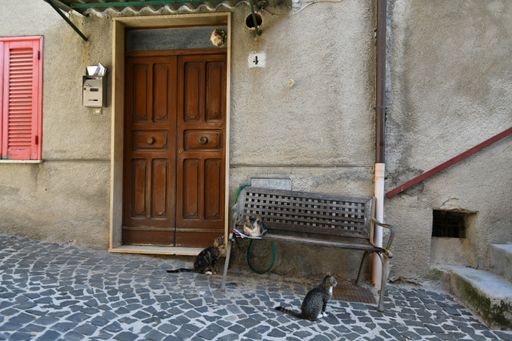 A closeup of a narrow street among the old stone houses of Villa Santo Stefano, a medieval town