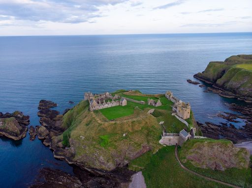 An aerial view of Dunnottar Castle on a hill in England