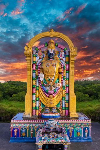 A vertical shot of the world's tallest Murti of Venkateshwara Swamy in India during sunset