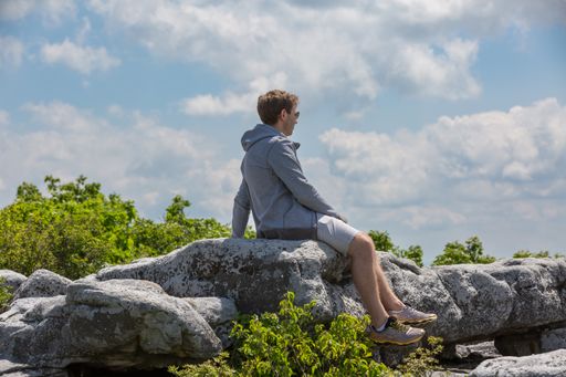 A young Caucasian man looking at the mountains in the Bear Rocks in Dolly Sods Wilderness Area, WV, USA