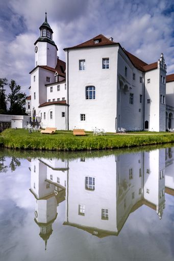 A vertical shot of Drehna Castle in Brandenburg, Germany on cloudy sky background