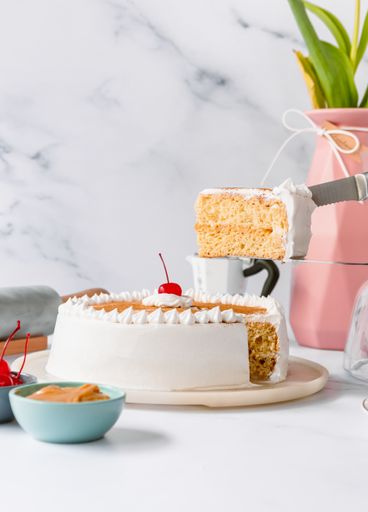 A vertical shot of a white sliced cake on a table