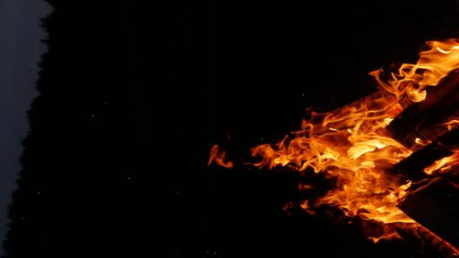A close-up shot of a big bonfire at night