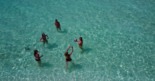 An aerial shot of a group of girls swimming in the ocean, Rasdhoo Island, Maldives