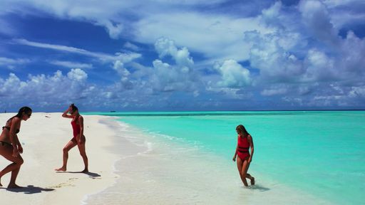 A group of women on the beach of Fulhadhoo Island, The Maldives