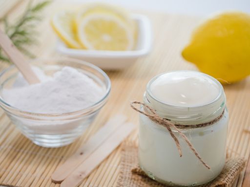 A closeup shot of natural skincare product ingredients: lemon, baking soda, and yogurt
